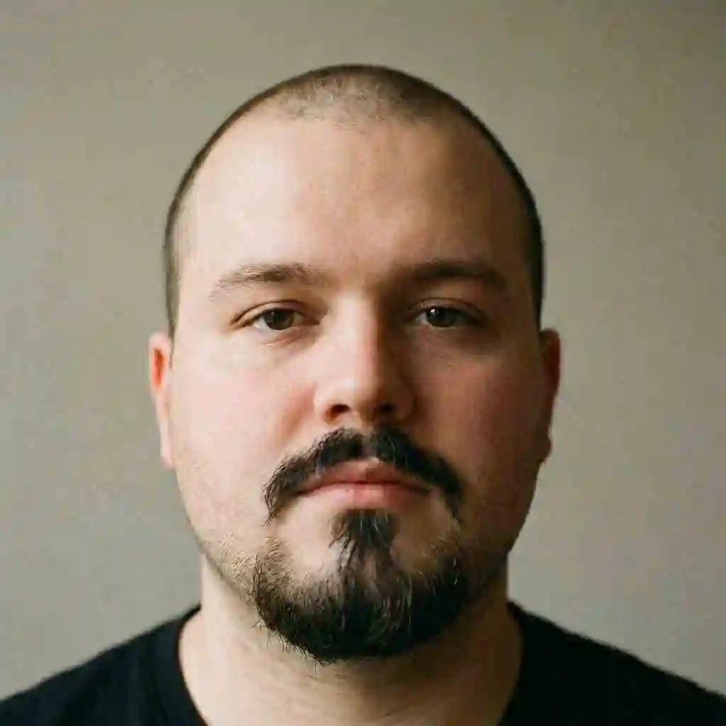 Man with a round face wearing a Van Dyke beard adding strong vertical lines which is a recommended beard for your face shape to reduce roundness.
