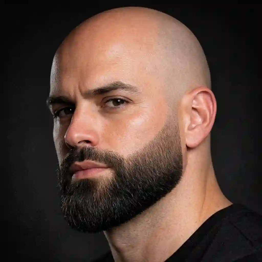 The modern faded beard features a seamless transition from the sideburns to the chin, making it an incredibly stylish and trendy option for guys seeking the best beard for bald head with a contemporary masculine edge.