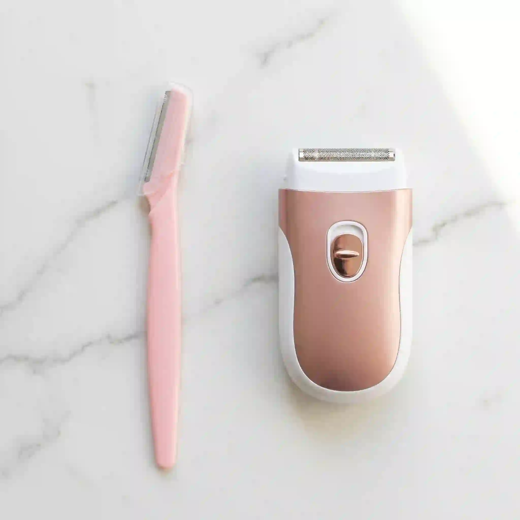 Women's facial shaver vs ladies facial razor comparison showing manual dermaplaning blade against electric foil shaver designs